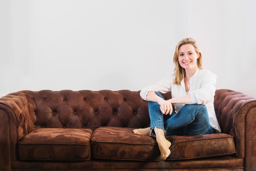 A lady sitting on her couch